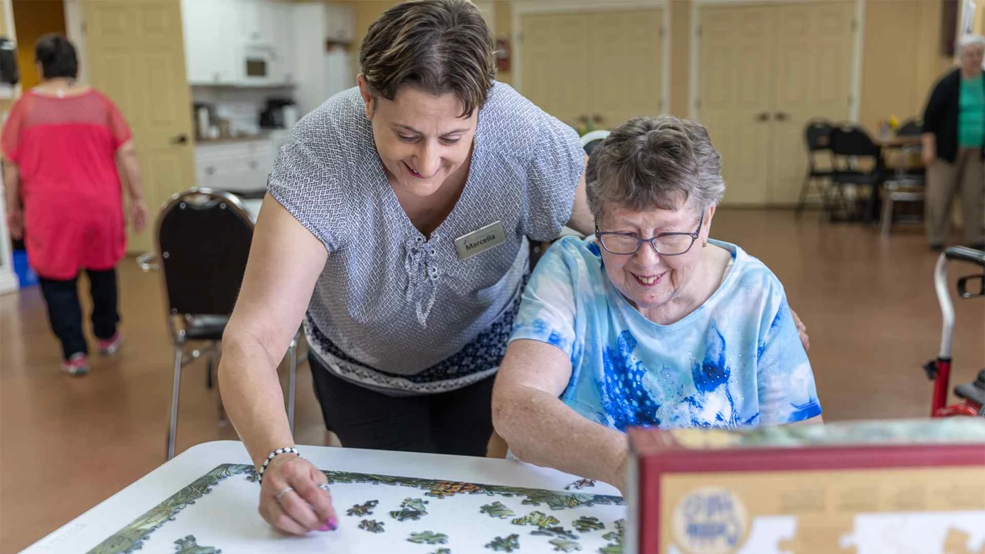 Two elderly women playing puzzle at CV