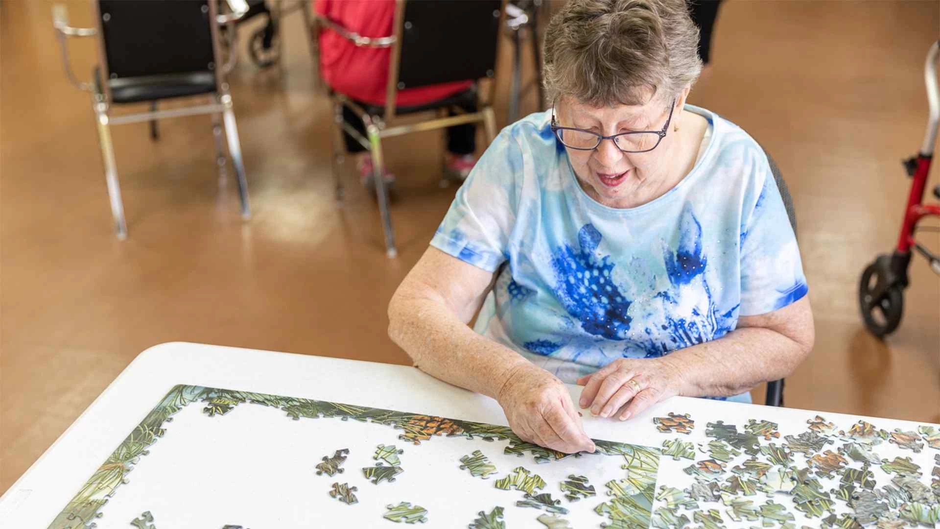 An elderly lady playing puzzle